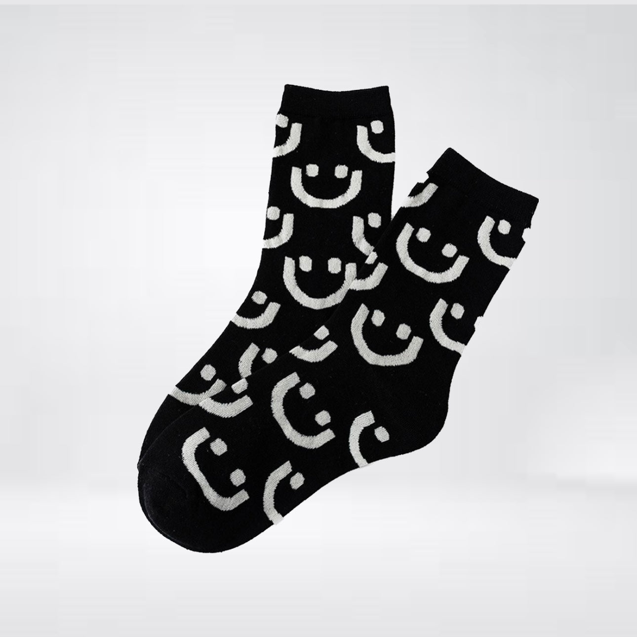 "Allover" socks in black with gray and white smileys